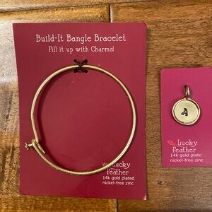 Gold bangle bracelet with the letter “A” charm